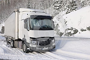 Transport truck stuck in the snow at the cold winter.