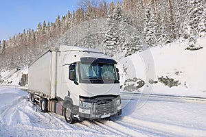 Transport truck stuck in the snow at the cold winter.