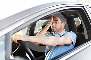 Tired sleepy man or driver driving car