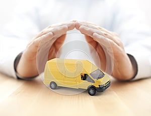 Transport yellow van car protected by hands