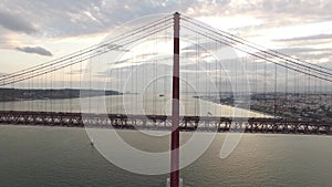 Transportation on 25 April bridge in Lisbon at evening