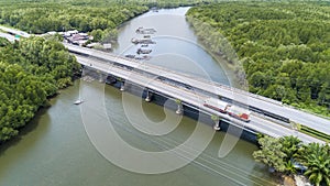 Transportation background of car truck on the bridge road with mangrove forest around the road