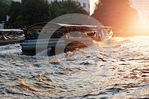 Transportation boat on the river city on sunset