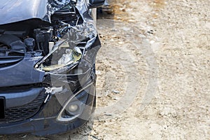 Close up front of black color car damaged and broken by accident on road