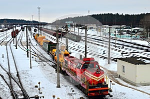 Transportation of dump trucks Belaz by rail. Heavy yellow mining truck disassembled on a railway platform.