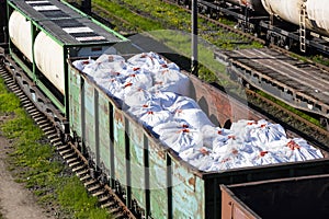 Transportation of fertilizers in huge bags and wagons by rail. Fertilizer cars, freight train