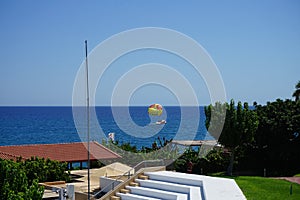 Parasailing in the Mediterranean. Parasailing is a recreational kiting activity where a person is towed behind a vehicle. Rhodes