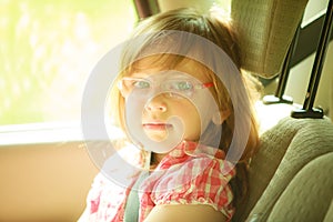 Transportation. Little girl child kid sitting in the car