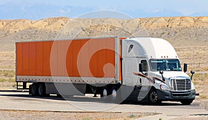 Transportation luxe semi truck trailer on scenic highway.