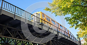 Transportation means. Yellow electric train, Berlin, Kreuzberg east side, Germany. Under view photo