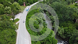 Transportation truck passing on the traffic road next to  river. Aerial view