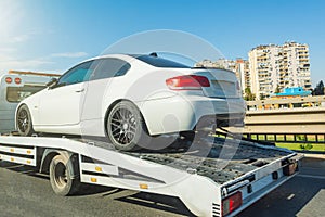 Transportation of an undamaged car in the back of a tow truck highway city