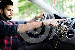 Transportation and vehicle concept - Indian man pressing red triangle car hazard warning button