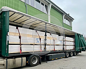 Transporting boards in a semi-trailer truck. Semi-trailer loaded with boards