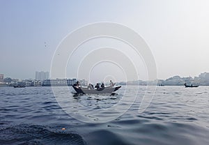 Transporting local people by small boats across the river, Commuter ferryboat in the monsoon, Boat ride in the Buriganga river.