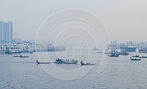 Transporting local people by small boats across the river, Commuter ferryboat in the monsoon, Boat ride in the Buriganga river.