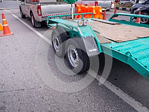 Transporting small  cargo trailer for a car strapped