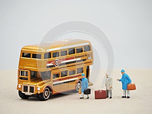 Transportion concept design. Double decker bus Routemaster with miniature toy of passengers.