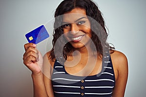 Transsexual transgender customer woman holding credit card over isolated white background with a happy face standing and smiling