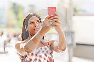 Transsexual woman taking a selfie outdoors. Close up