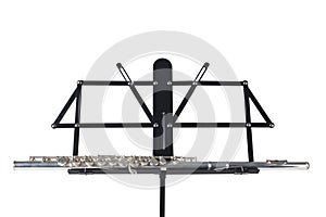 Transverse flute rest on a music stand isolated on white background with clipping path and copy space for your tex