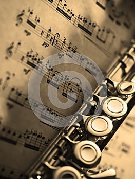 Transverse flute resting on an eighteenth-century classical music score