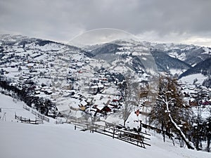 Transylvania Romania in winter season with mountain houses and trees in the village of Parva. Winter landscapes photo