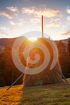 Transylvanian mountains with typical bales on the hillside, Bihar mountains, Carpathian mountains at sunrise