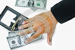 Trap with dollar bills isolated over white background, Risk in business, Businessman taking money from a mousetrap