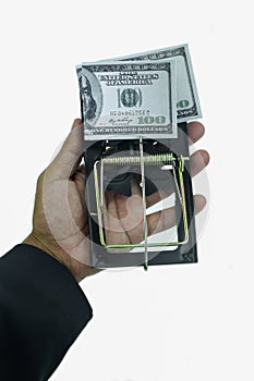 Trap with dollar bills isolated over white background, Risk in business, Businessman taking money from a mousetrap