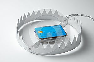 Trap with stack of credit cards. Unsafe credit risk. Gray background.