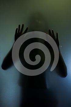 Trapped woman concept with back silhouette of hands