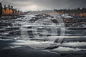 Trappstegsforsen waterfall in autumn along the Wilderness Road in Lapland in Sweden