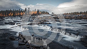 Trappstegsforsen waterfall in autumn along the Wilderness Road in Lapland in Sweden