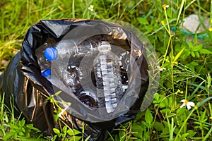 Trash bag and plastic bottle collect from around forest