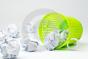 Trash bin and crumpled paper balls