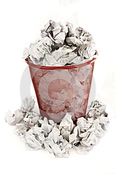 Trash bin is filled with paper waste