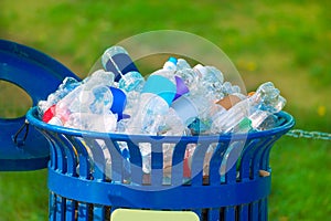 Trash bin full of beverage empty bottles