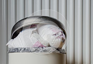 Trash bin full of used diapers. Close up