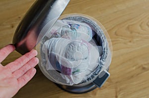 Trash bin full of used diapers. Close up