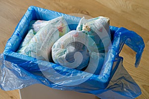 Trash bin full of used diapers