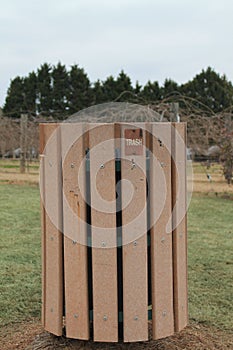 Trash bin in a green fild