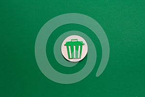 Trash Bin Icon on Green Background representing waste disposal photo