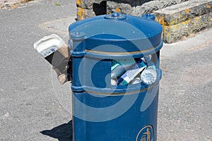 Trash bin stuffed with plastic rubbish