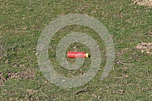 Trash bottle on a field