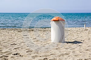 Trash can on the beach sunny day. Concept photo of a clean beach