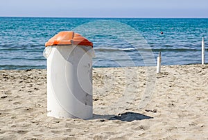 Trash can on the beach sunny day. Concept photo of a clean beach