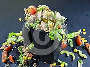 Trash can filled with wasted food photo