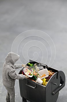 A trash can full of food that is still edible but thrown away miniature photo