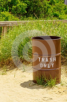 Trash can on hot sands of seaside